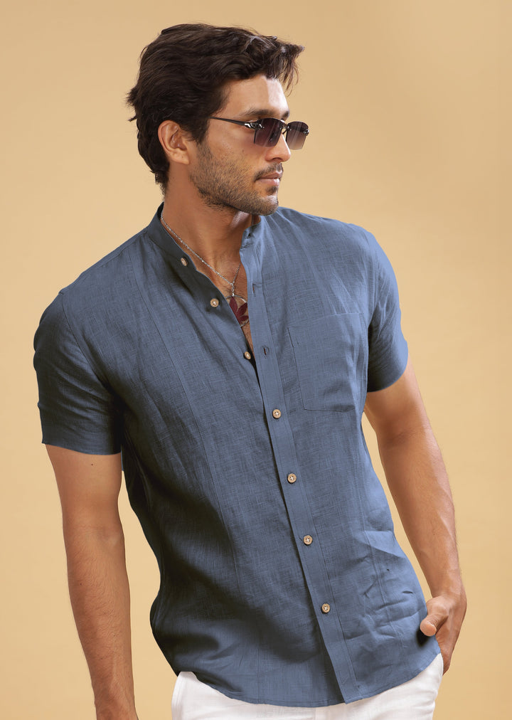 A man wearing a short sleeve pure linen shirt with a mandarin collar, in gunmetal grey color.