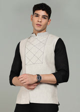 Man wearing an ecru 100% pure linen embroidered vest in 25 LEA over a black shirt on a gray background