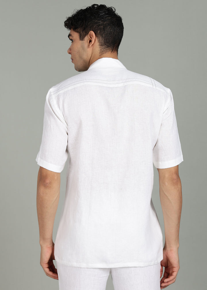 Man wearing a 100% pure linen white shirt in 44 LEA with elephant embroidery on a gray background