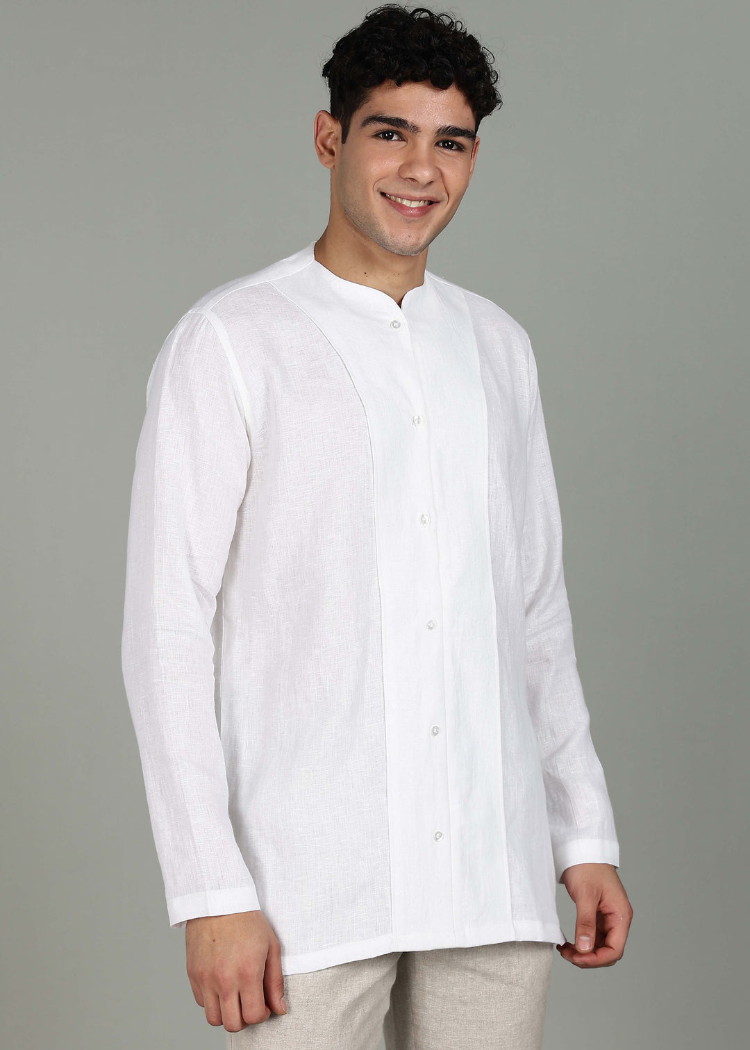 Man wearing a 100% pure linen white long-sleeve kurta in 44 LEA against a gray background