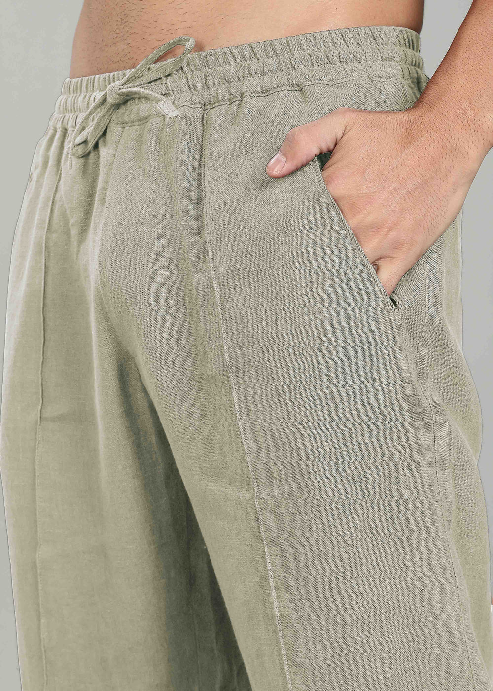 100% pure linen artichoke green pants with a drawstring waist on a neutral background