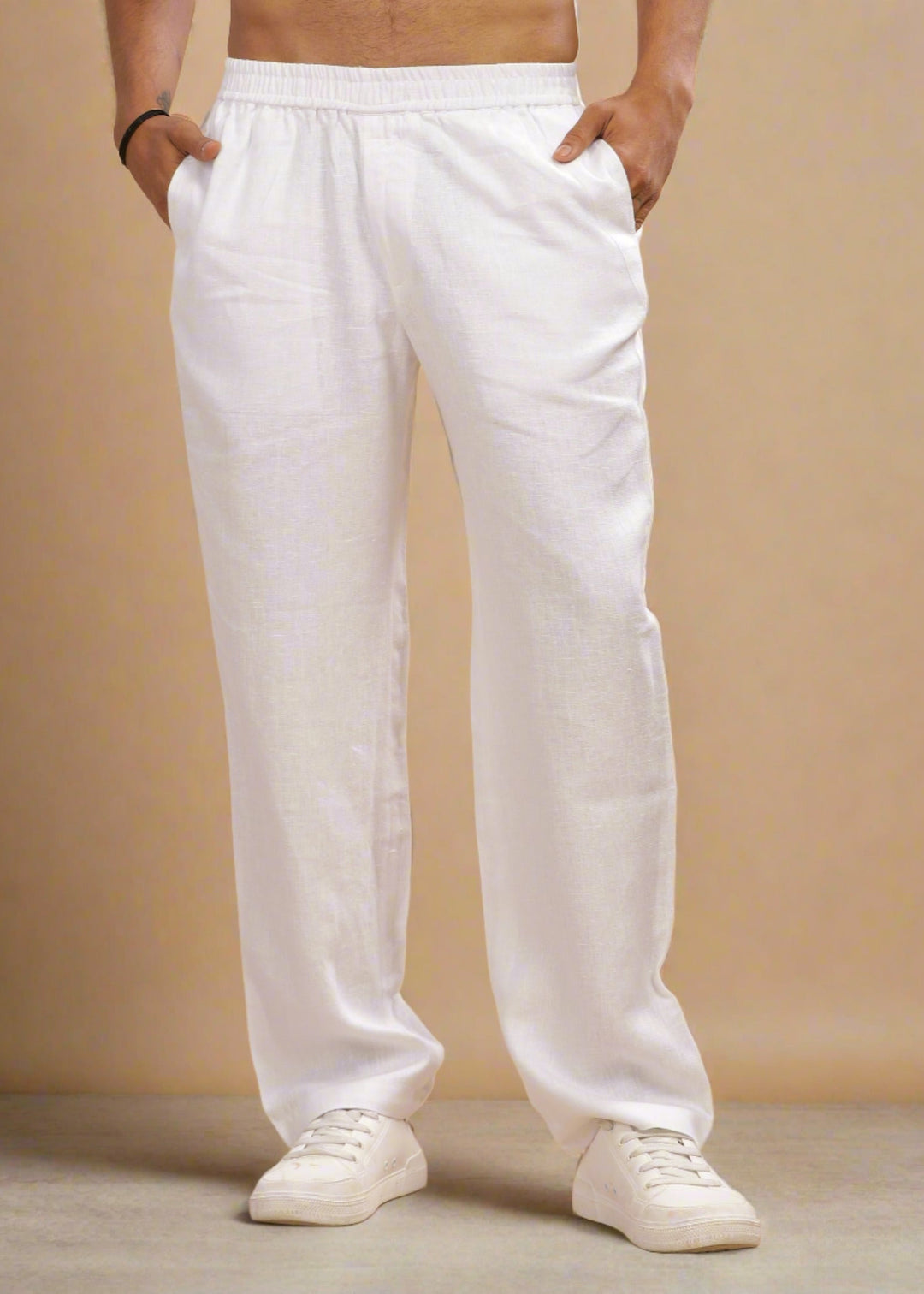 A pair of white linen casual elastic pants, displayed on a model without showing the upper part of the body.