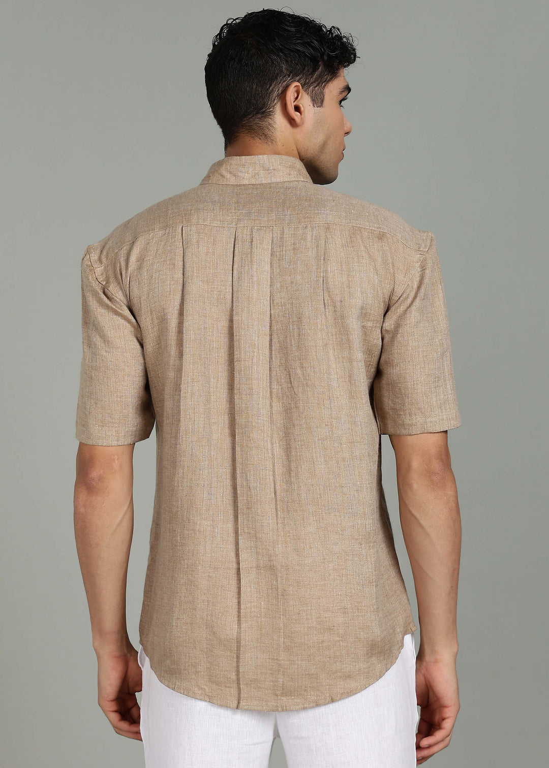Man wearing 100% 60 LEA Mocha Half sleeve Shirt in an indoor grey background.
