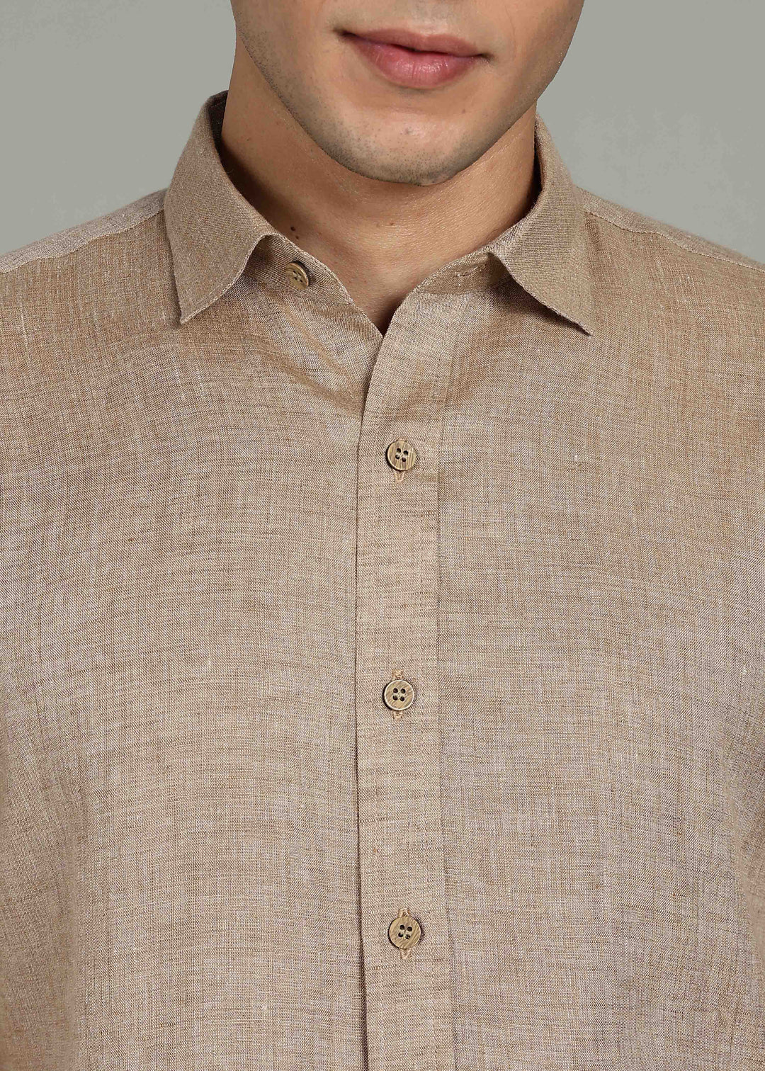 Man wearing 100% 60 LEA Mocha Half sleeve Shirt in an indoor grey background.