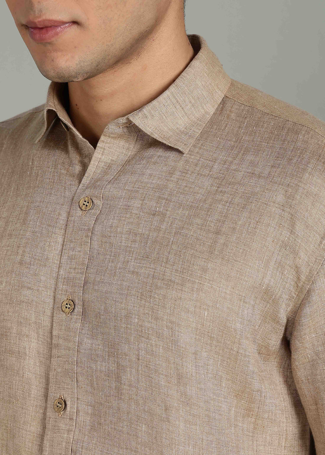 Man wearing 100% 60 LEA Mocha Half sleeve Shirt in an indoor grey background.