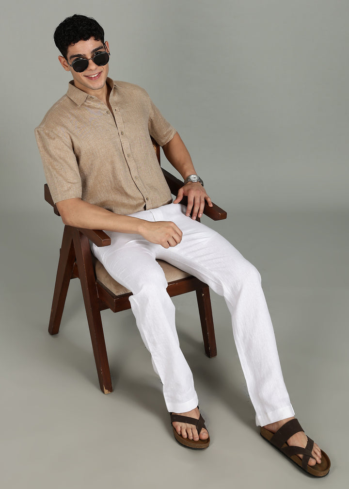 Man wearing 100% 60 LEA Mocha Half sleeve Shirt in an indoor grey background.