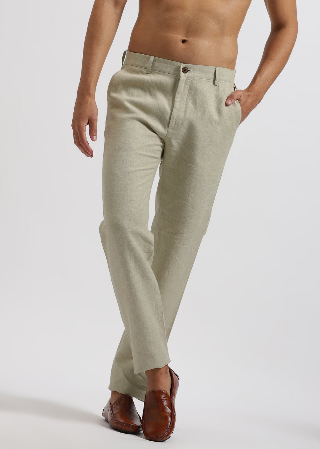 Beige pure linen pants worn by a person on a white background