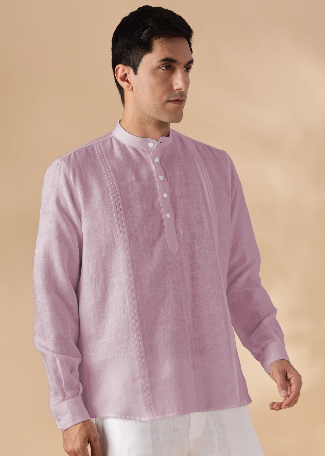 Man wearing a 100% pure linen cameo pink short kurta on a beige background