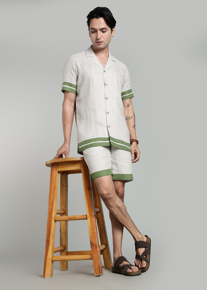 Man wearing 100% pure linen cuban-collar shirt and shorts in pure ecru with cossack-green accents in 60 LEA(shirt) & 25 LEA(shorts)