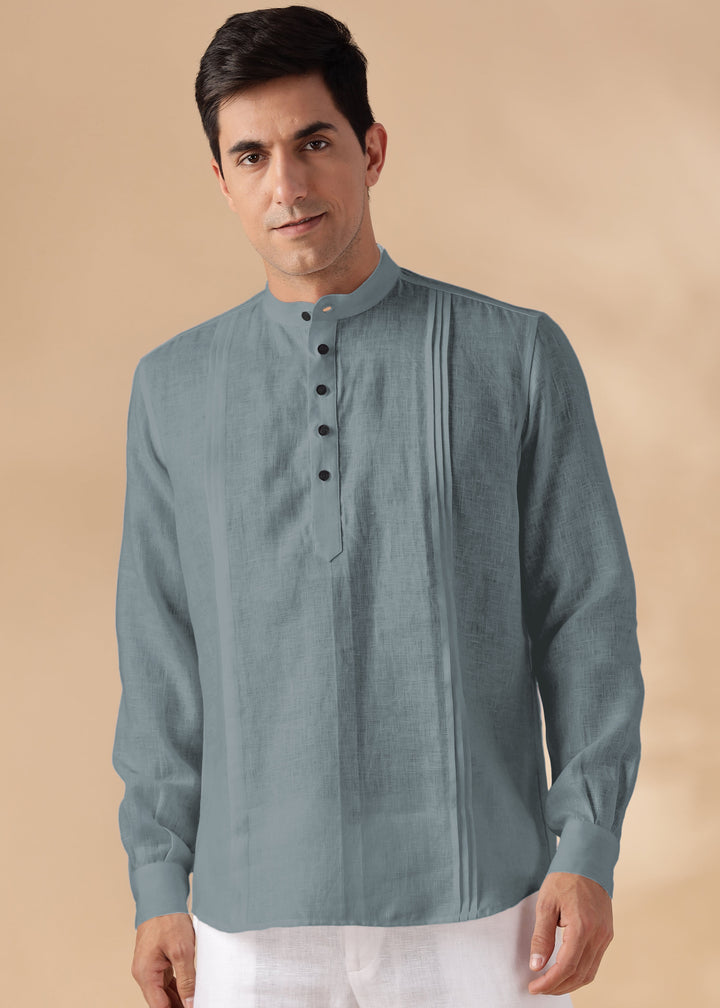 Man wearing a 100% pure linen mineral grey short kurta with white pants on a beige background