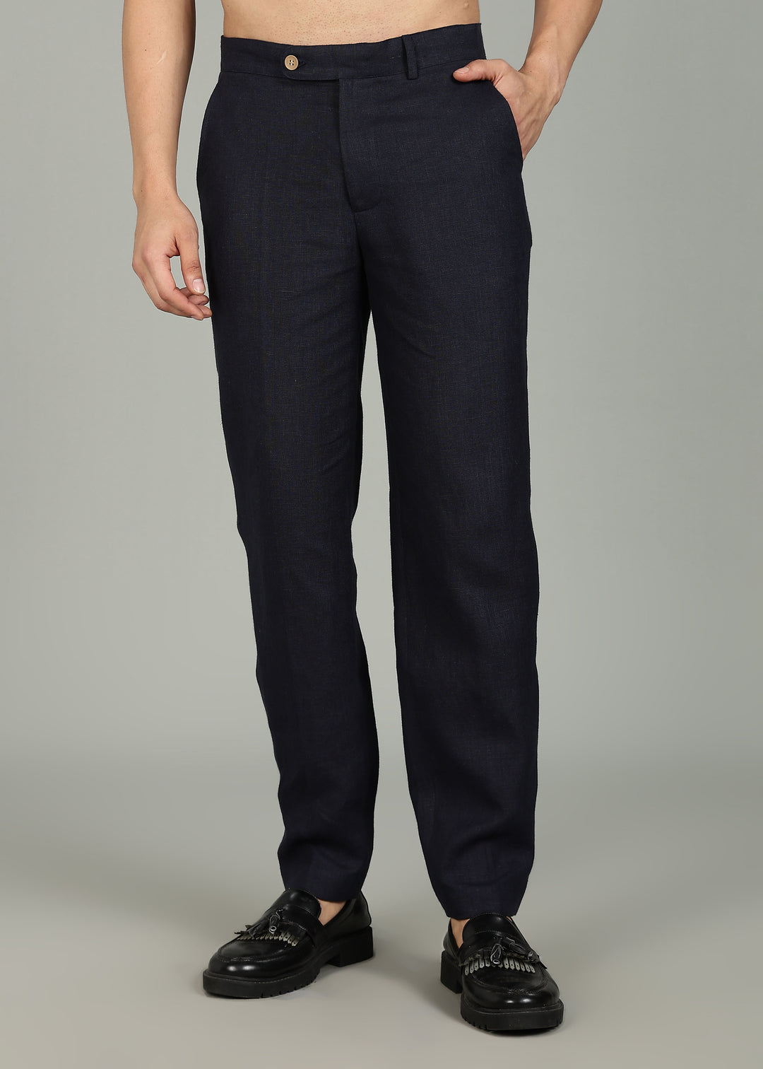 Man wearing 100% 25 LEA Regal Blue formal pants in an indoor grey background.