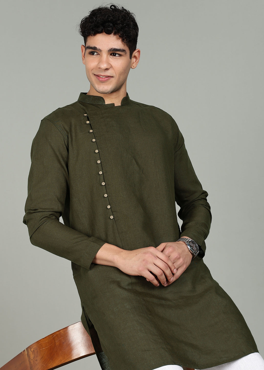 Man wearing a 100% Moss Green 60 lea Kurta, with placket detail, in a Grey  Background indoor.