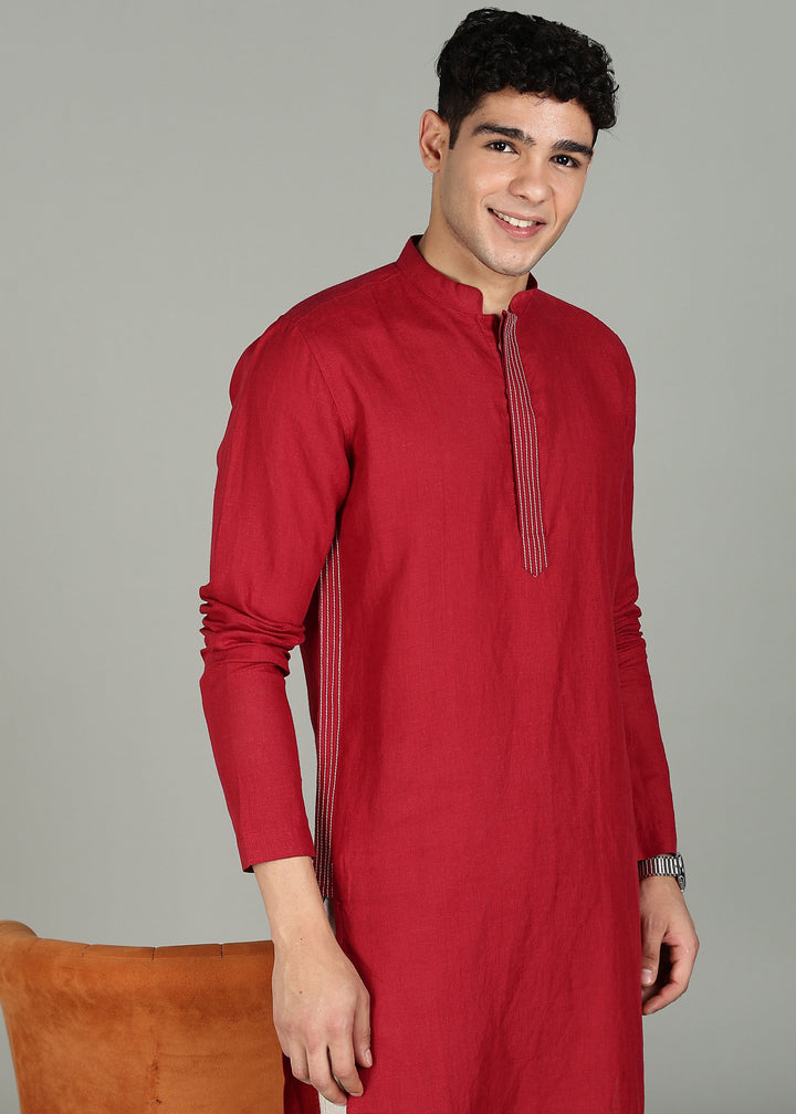 Man wearing a 100% pure linen mud red long kurta in 60 LEA with white detailing against a gray background