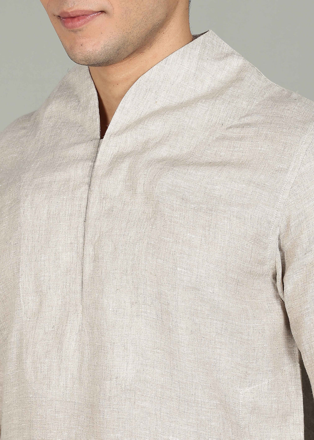 Man wearing a 100% pure linen Ecru Kurta, in a grey background indoor.