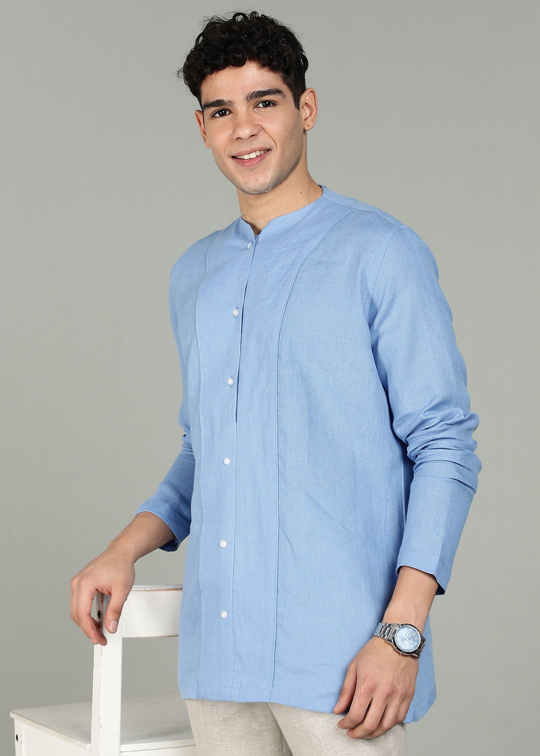 Man wearing a 100% pure linen olympic blue long-sleeve kurta in 60 LEA against a gray background