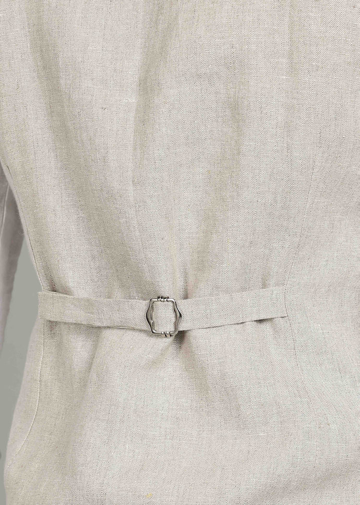 Man wearing a 100% pure linen ecru waistcoat in 25 LEA over a white shirt against a gray background