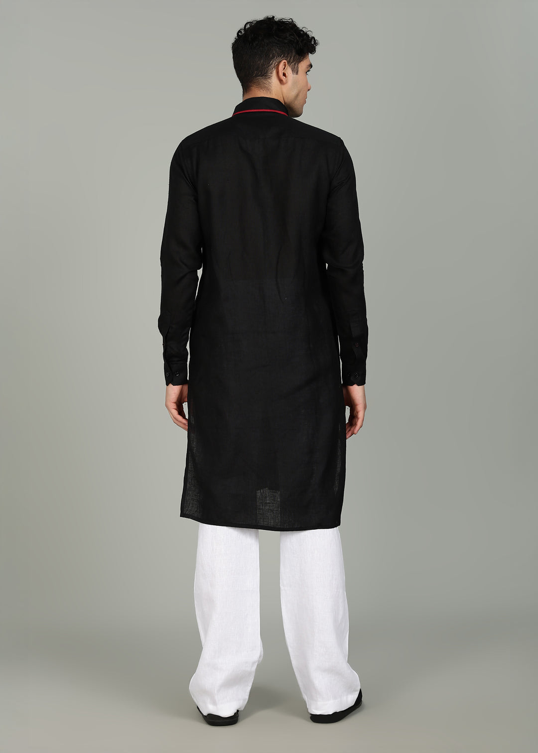 Man wearing a 100% pure linen black long kurta in 60 LEA with red piping detail with a gray background