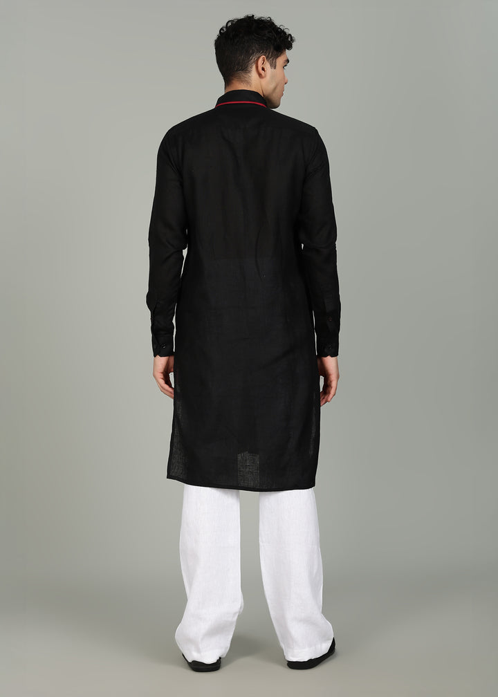 Man wearing a 100% pure linen black long kurta in 60 LEA with red piping detail with a gray background