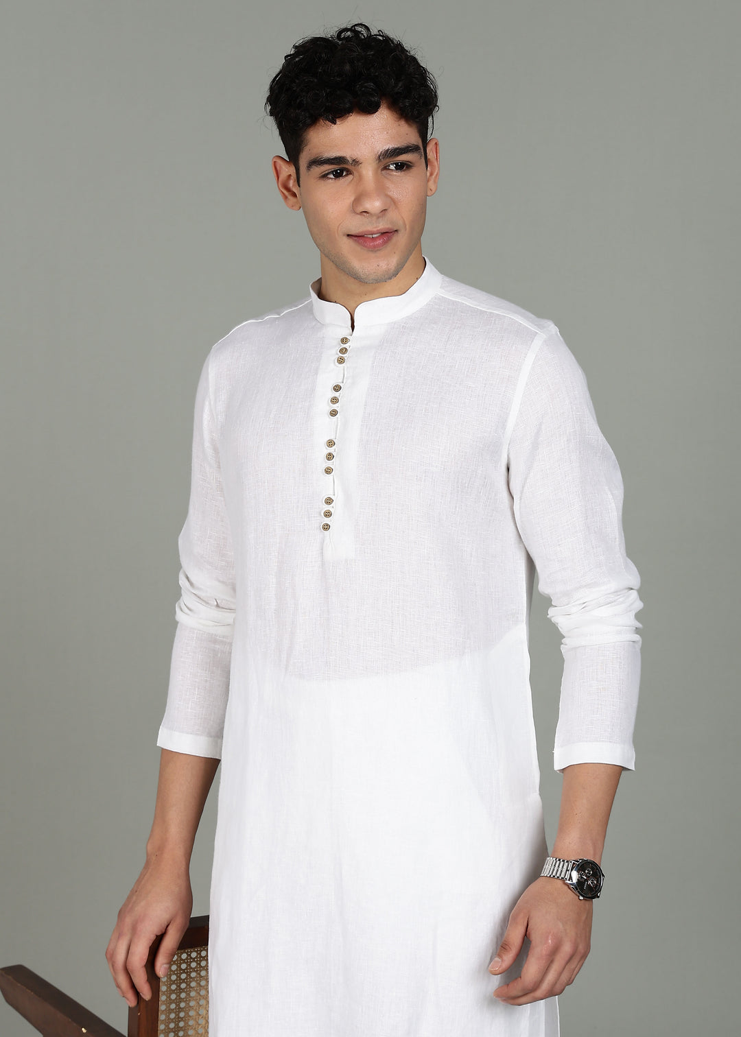 Man wearing a 100% pure linen white long kurta with pink floral design on the back in 44 LEA against a gray background