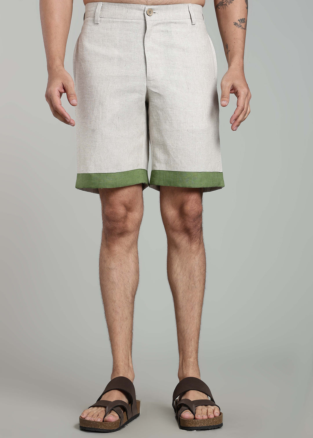 Man wearing 100% pure linen shorts in pure ecru with cossack-green accents in 25 LEA