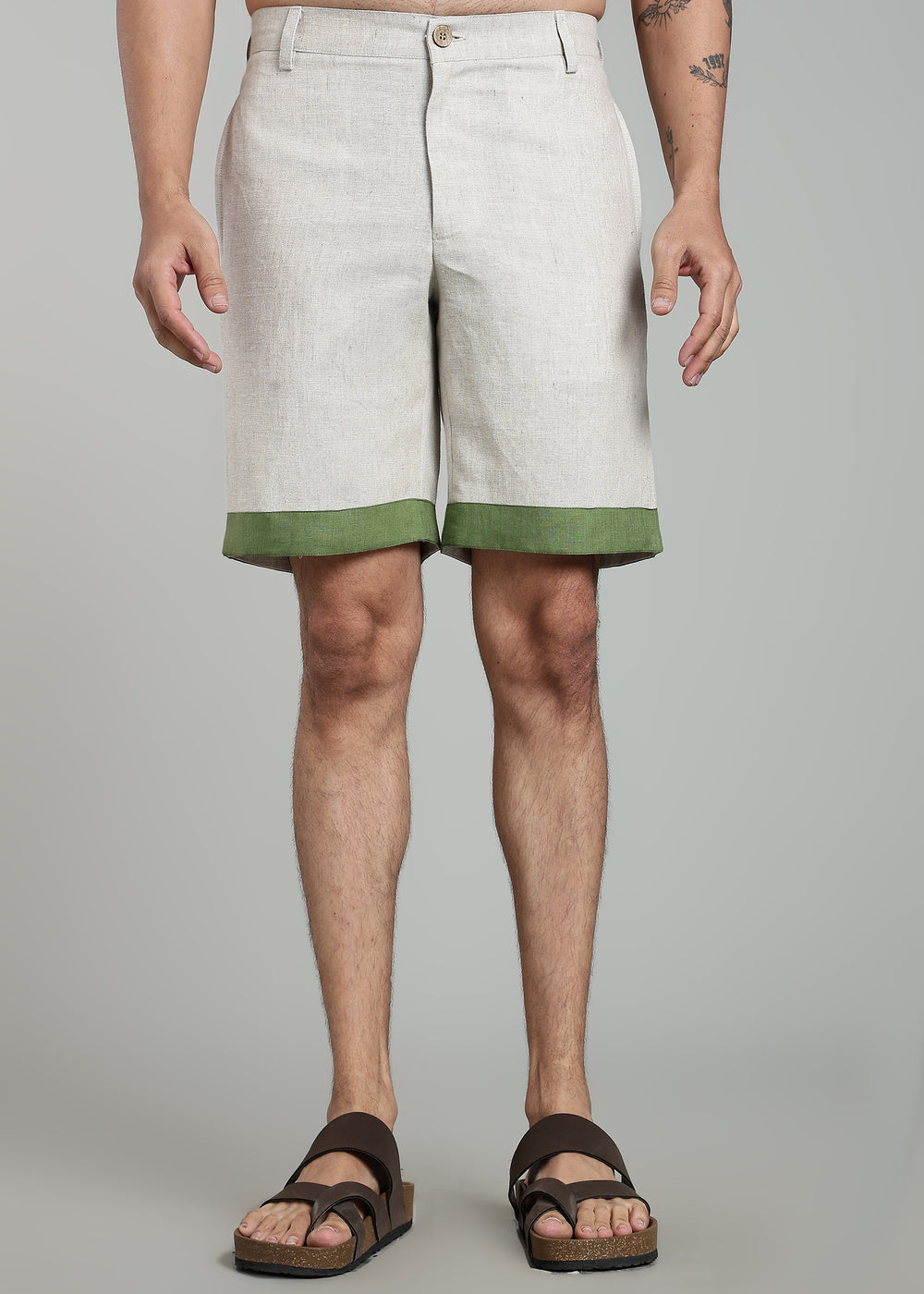 Man wearing 100% pure linen cuban-collar shirt and shorts in pure ecru with cossack-green accents in 60 LEA(shirt) & 25 LEA(shorts)