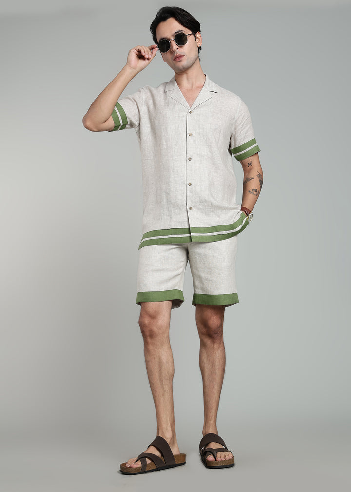Man wearing 100% pure linen cuban-collar shirt in pure ecru with cossack-green accents in 60 LEA
