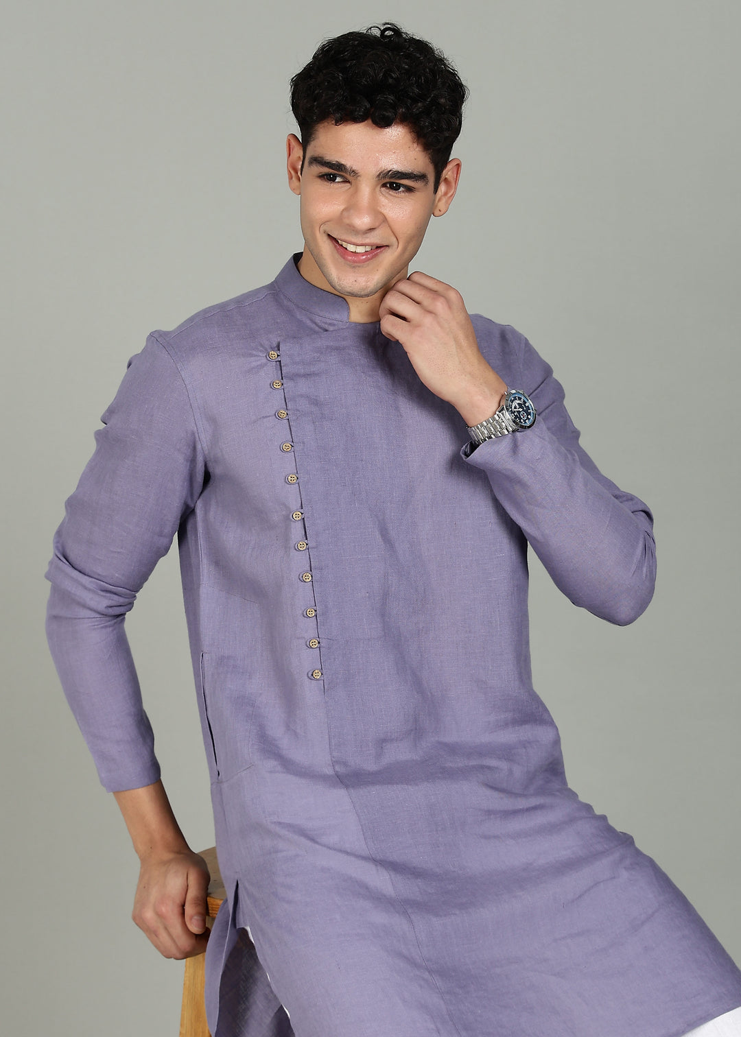 Man wearing a 100% Lavender violet 60 lea Kurta, with placket detail, in a Grey  Background indoor.