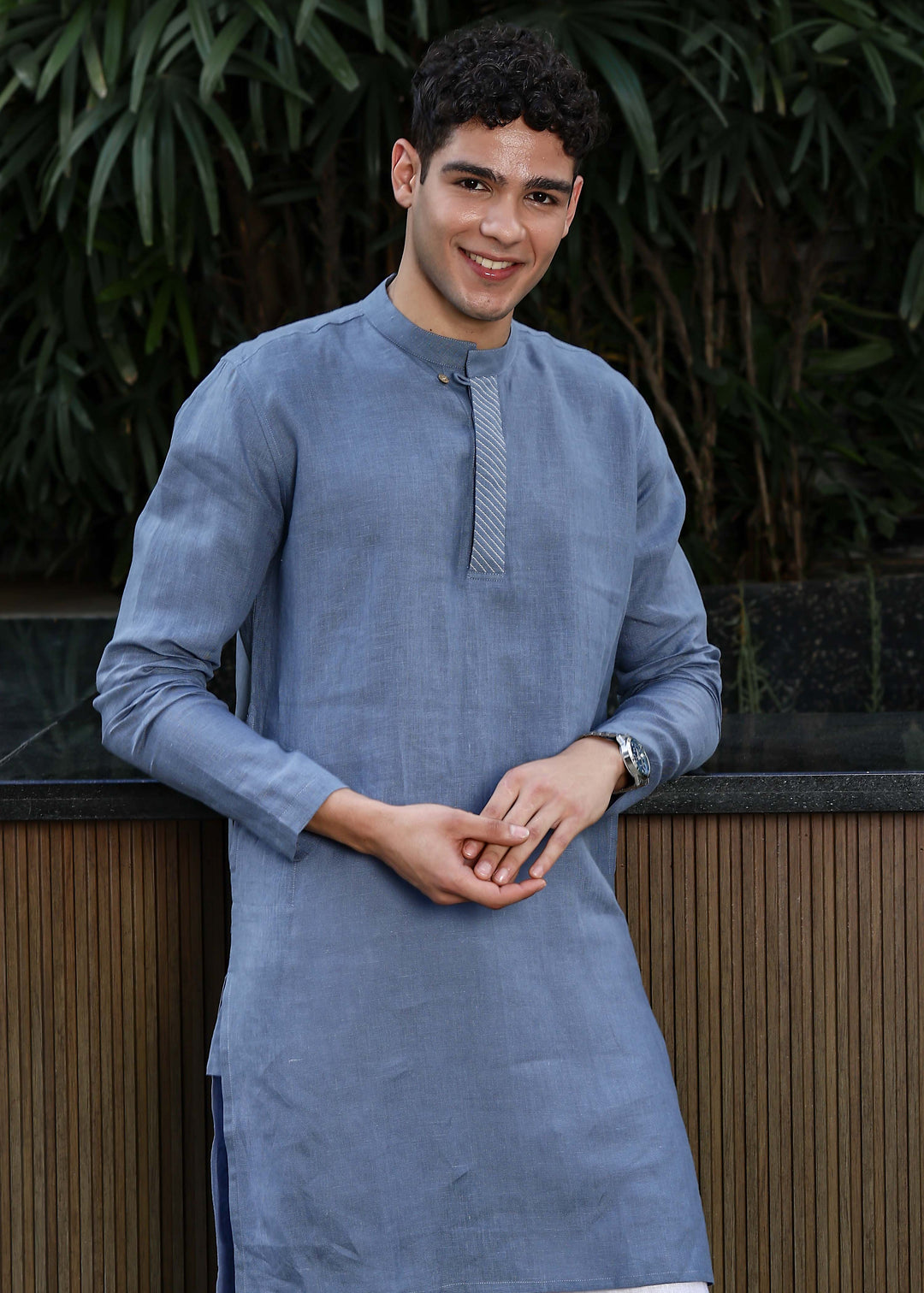 Man wearing Blue Grey Kurta, 100% pure linen, outdoor green background.