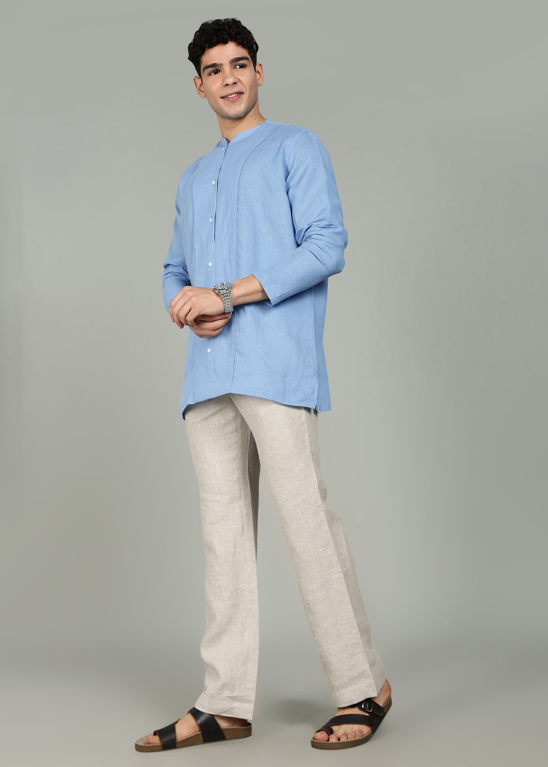 Man wearing a 100% pure linen olympic blue long-sleeve kurta in 60 LEA against a gray background