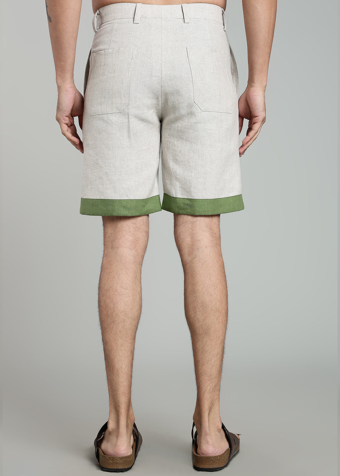 Man wearing 100% pure linen cuban-collar shirt and shorts in pure ecru with cossack-green accents in 60 LEA(shirt) & 25 LEA(shorts)