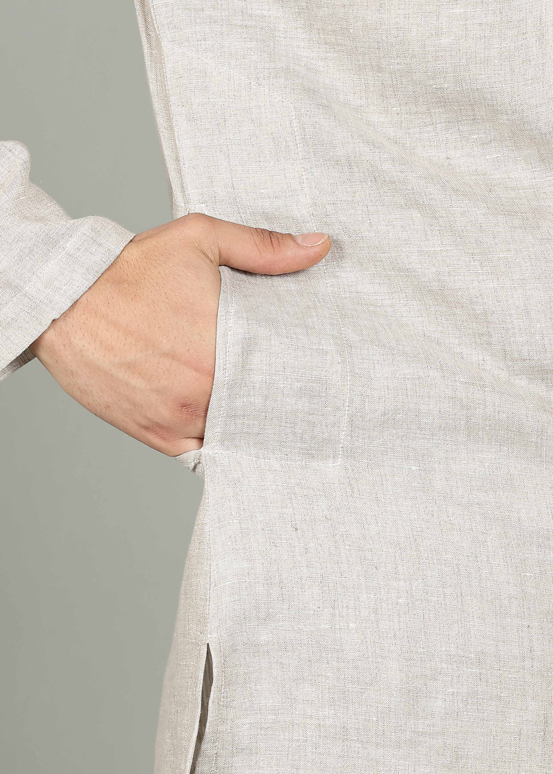 Man wearing a 100% pure linen Ecru Kurta, in a grey background indoor.