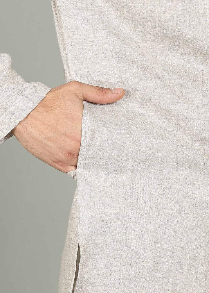 Man wearing a 100% pure linen Ecru Kurta, in a grey background indoor.