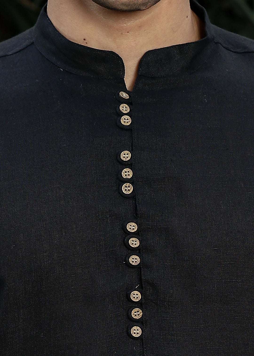 Man wearing a 100% pure linen black long kurta with pink floral design on the back in 60 LEA