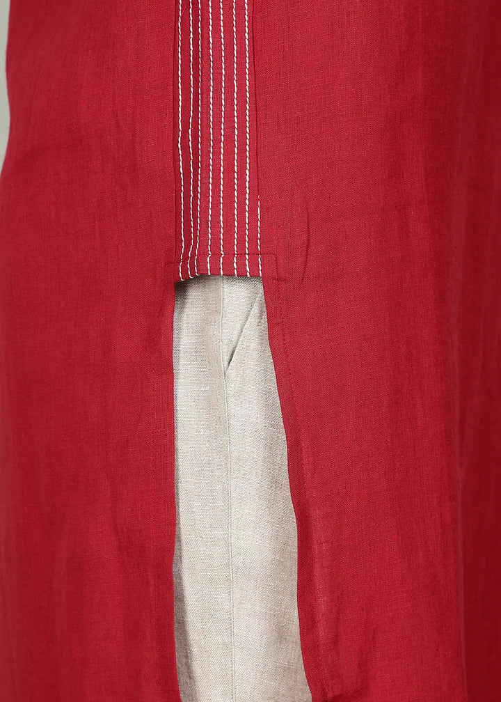 Man wearing a 100% pure linen mud red long kurta in 60 LEA with white detailing against a gray background