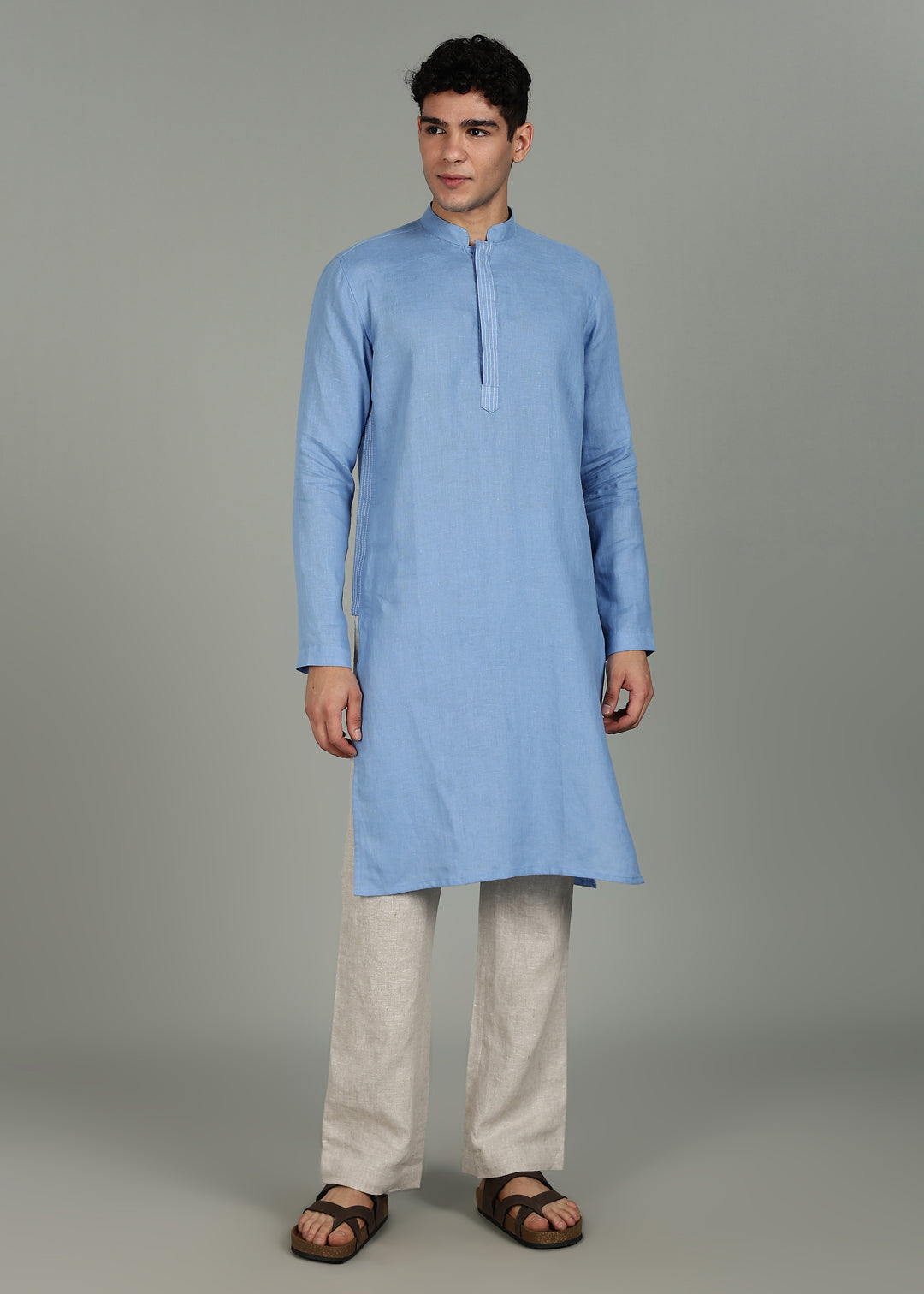 Man wearing a 100% pure linen olympic blue long kurta in 60 LEA with white detailing against a gray background