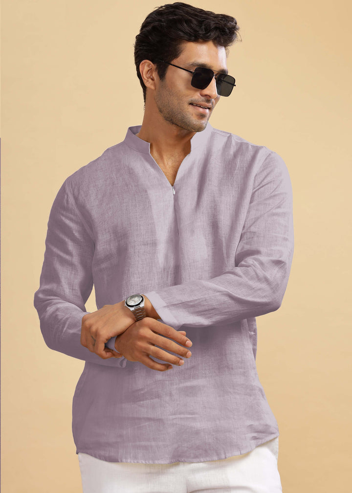 Man wearing a 100% pure linen cameo pink short kurta and sunglasses on a beige background