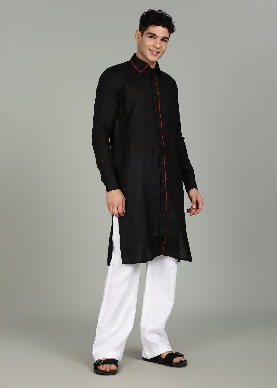 Man wearing a 100% pure linen black long kurta in 60 LEA with red piping detail with a gray background