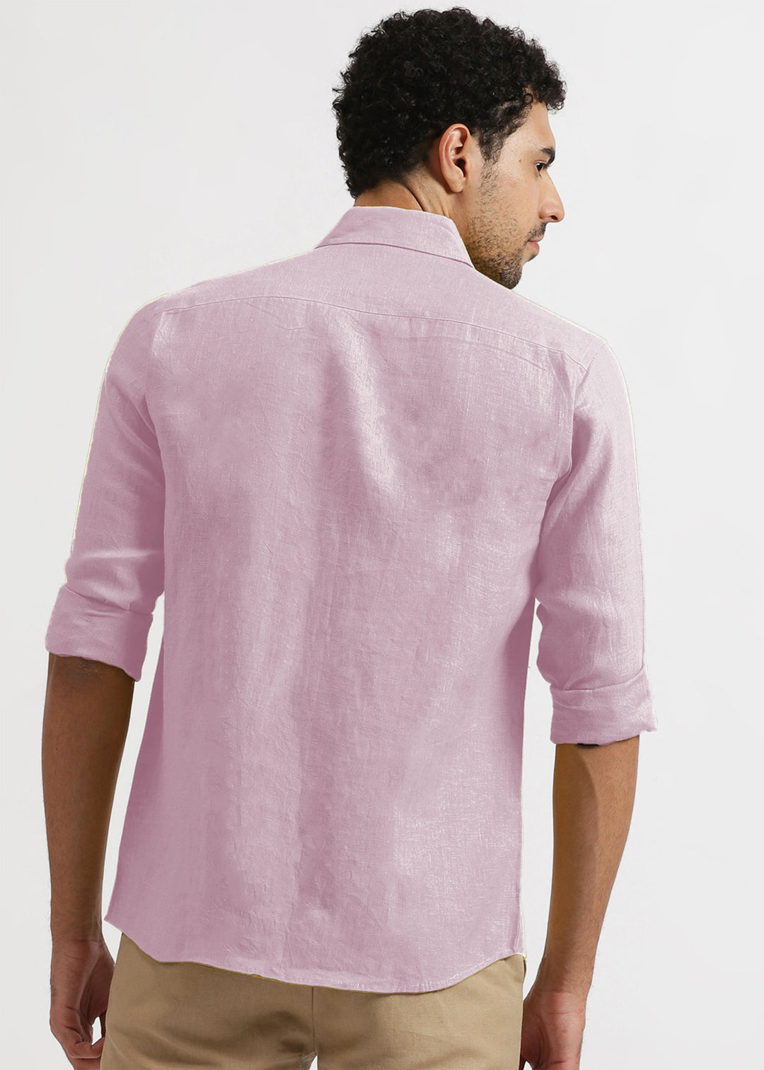 Man wearing a 100% pure linen hermosa pink shirt with rolled-up sleeves on a white background