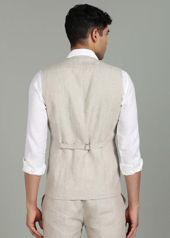 Man wearing a 100% pure linen ecru waistcoat in 25 LEA over a white shirt against a gray background