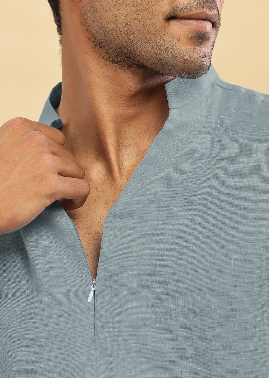 Man wearing a 100% pure linen mineral grey short kurta against a beige background