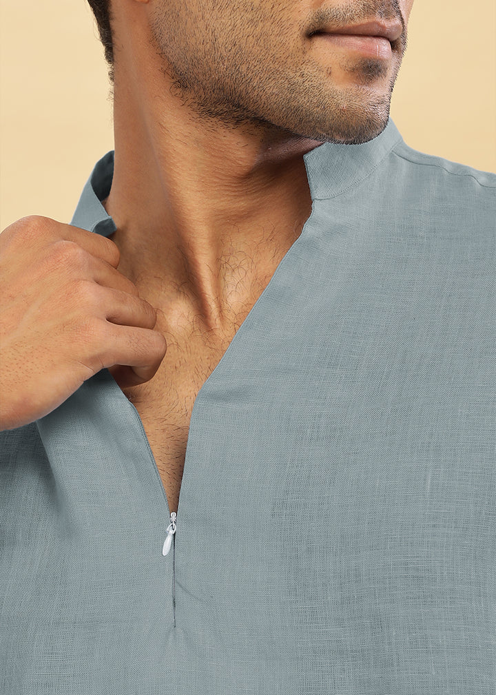 Man wearing a 100% pure linen mineral grey short kurta against a beige background