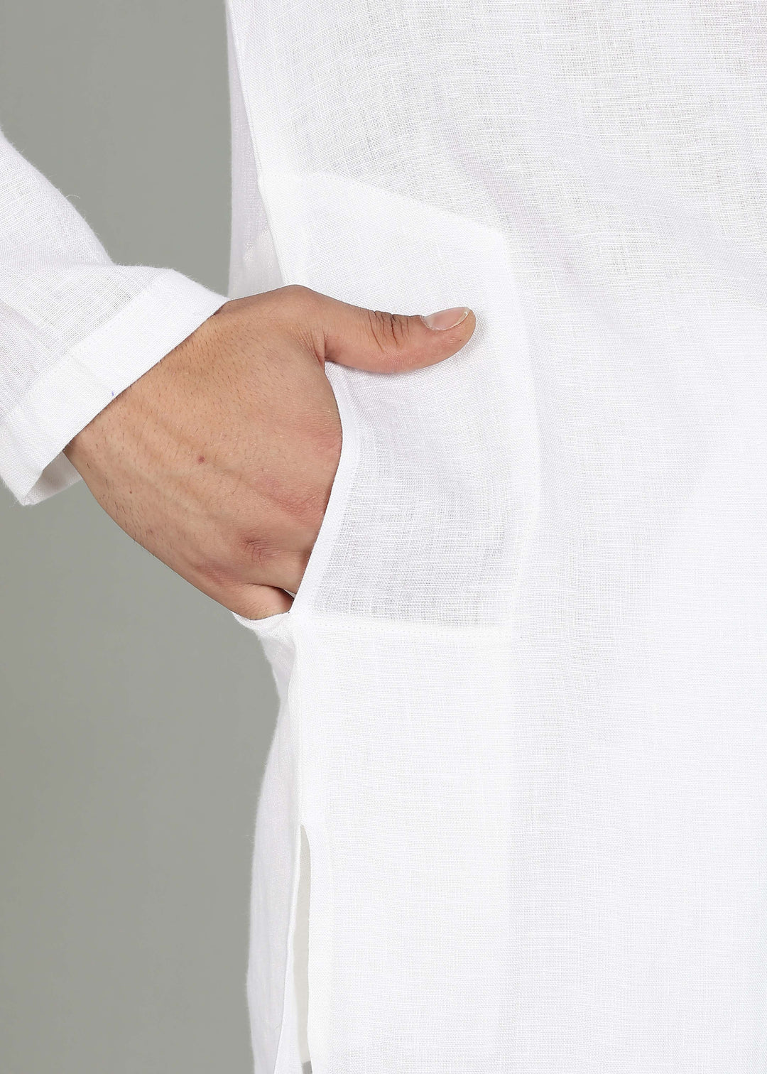 Man wearing a 100% pure linen white long kurta with pink floral design on the back in 44 LEA against a gray background