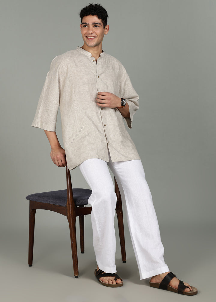 Man wearing a 100% pure linen ecru short kurta in 60 LEA with a gray background