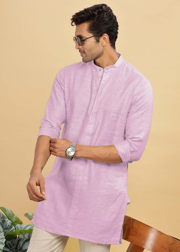 Man wearing a 100% pure linen hermosa pink kurta with sunglasses and a watch on a beige background