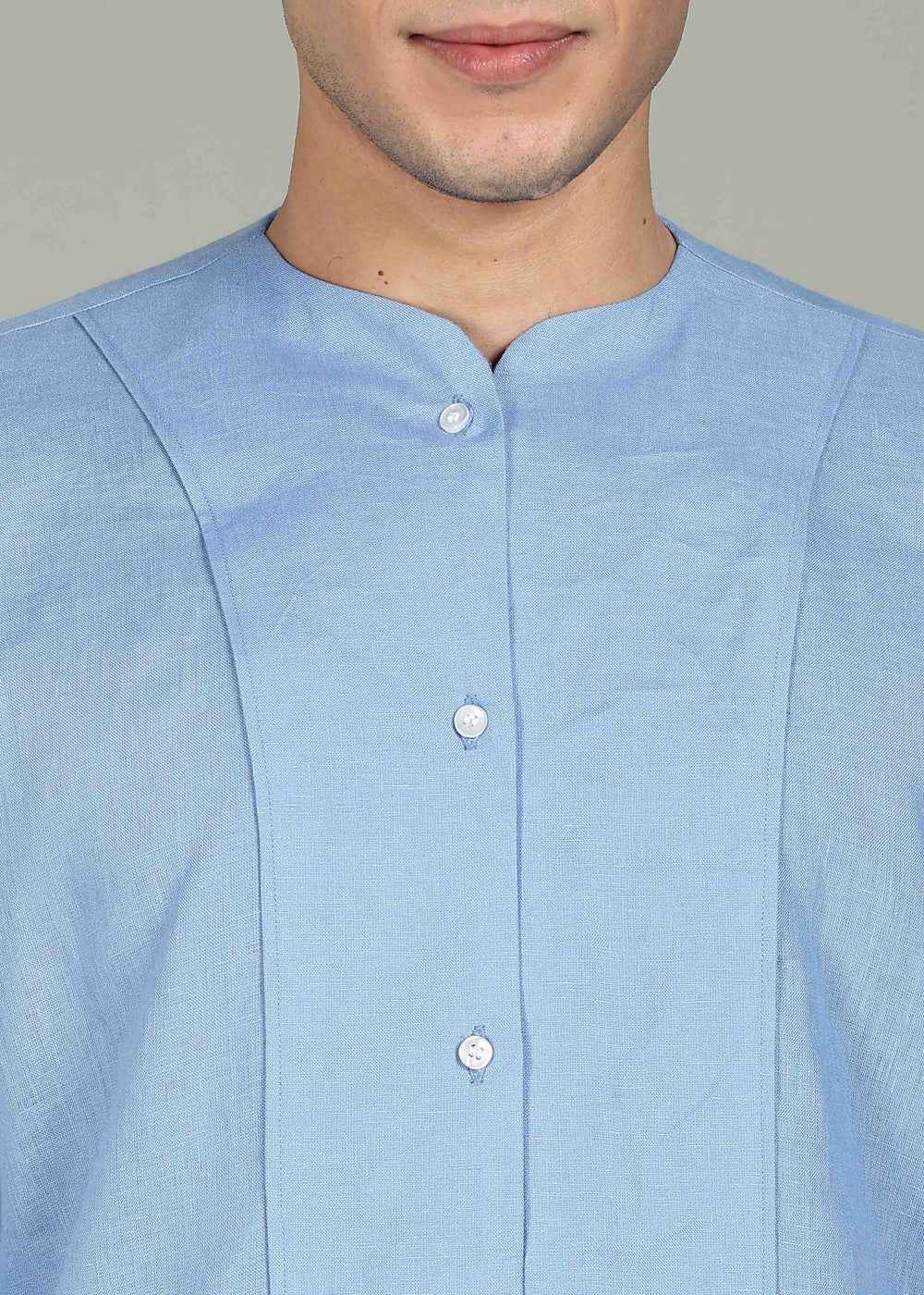 Man wearing a 100% pure linen olympic blue long-sleeve kurta in 60 LEA against a gray background