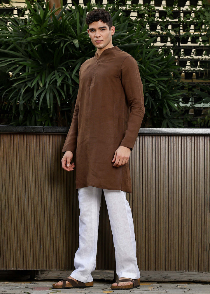 Man wearing a 100% pure linen Coffee Brown Kurta, in a green background outdoor.