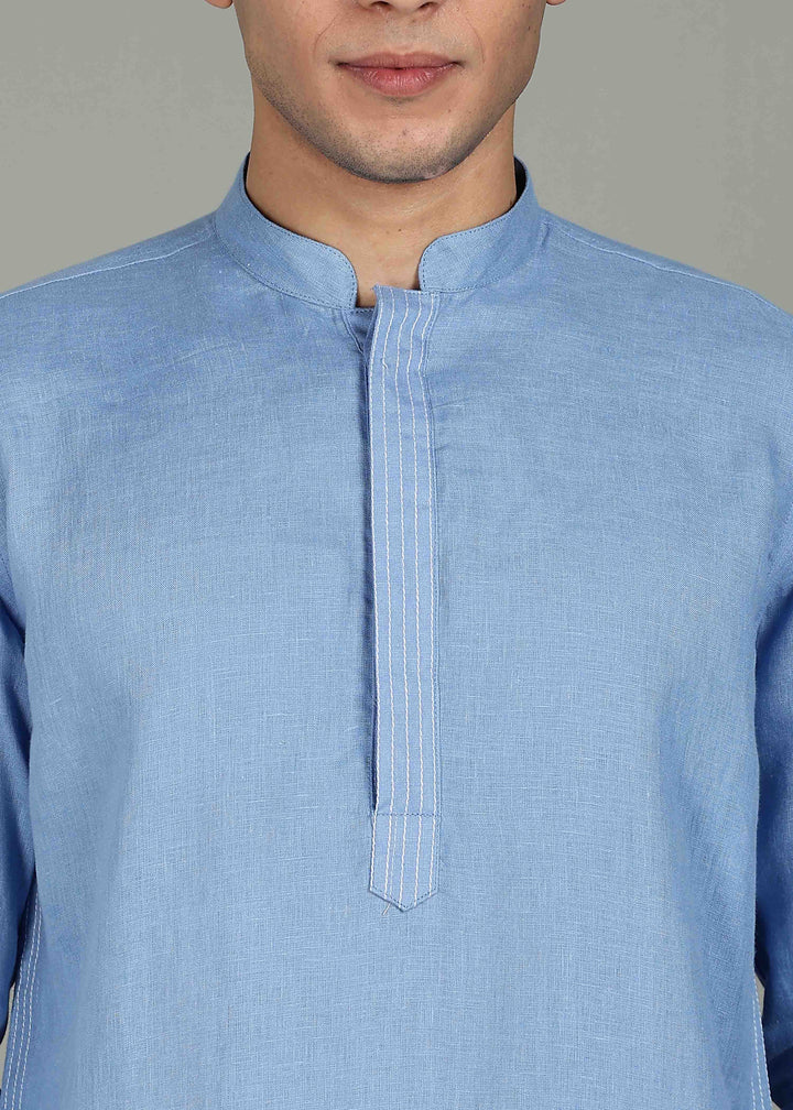Man wearing a 100% pure linen olympic blue long kurta in 60 LEA with white detailing against a gray background
