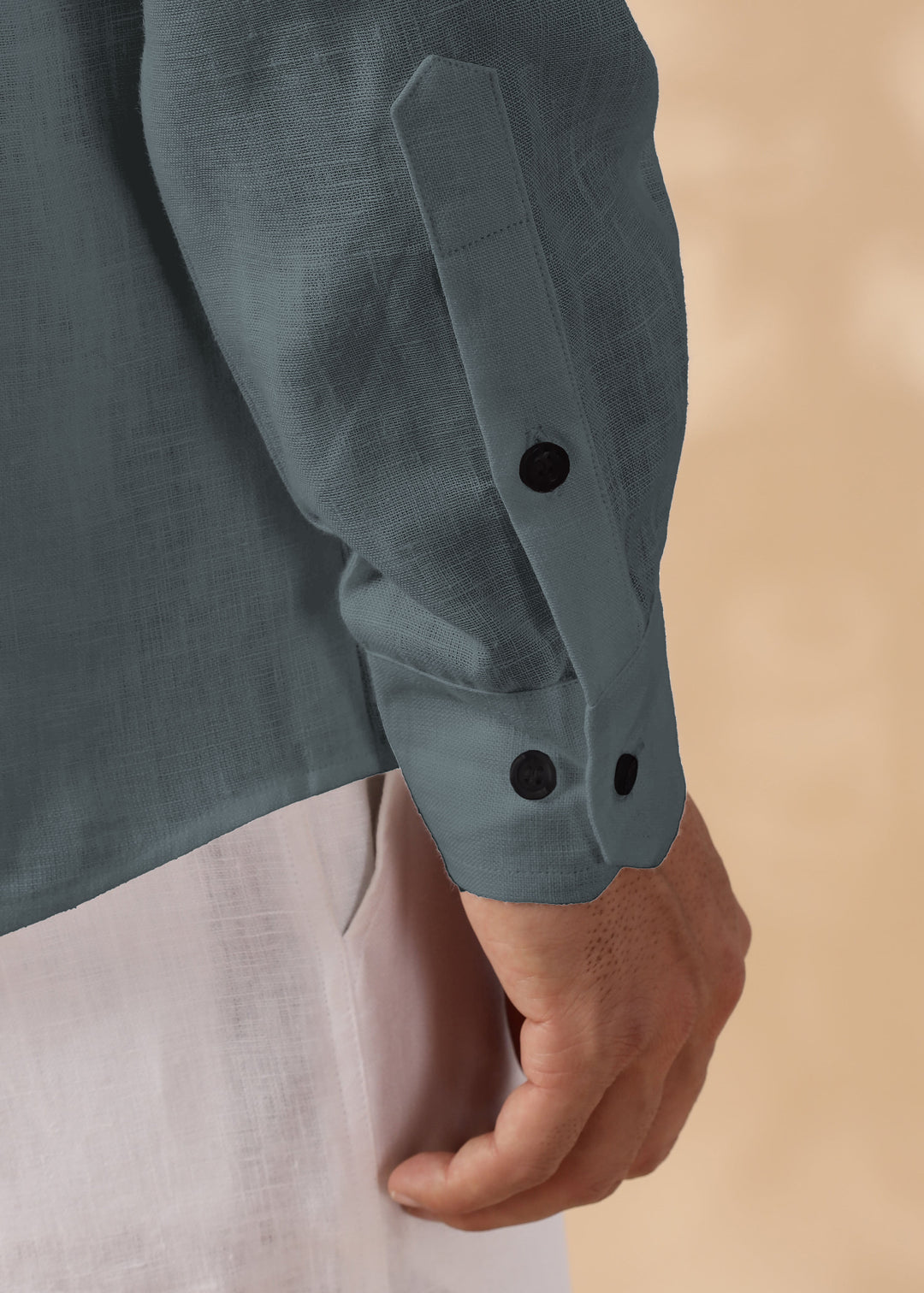 Close-up of a person wearing a 100% pure linen mineral grey short kurta on a beige background