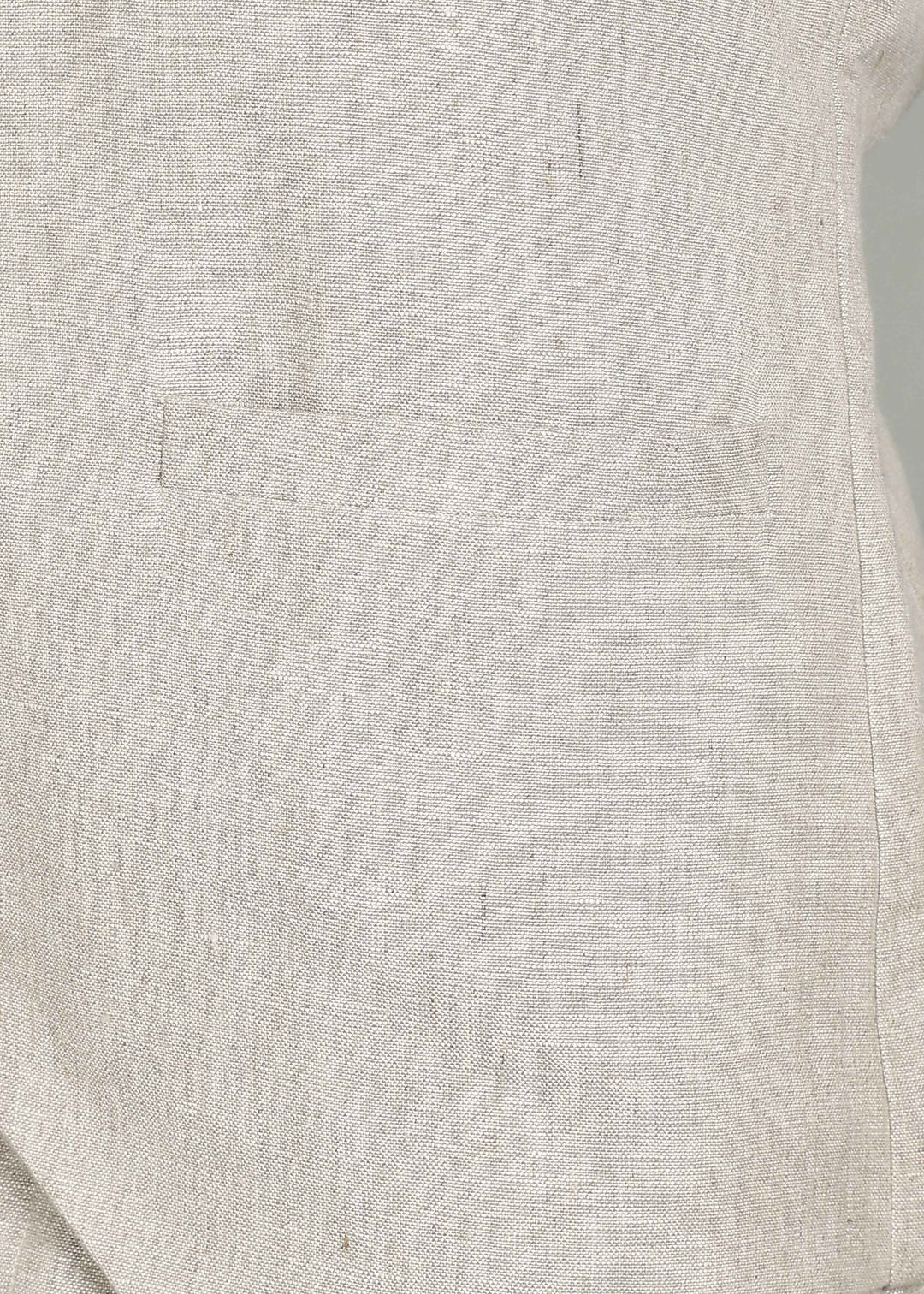 Man wearing a 100% pure linen ecru waistcoat in 25 LEA over a white shirt against a gray background
