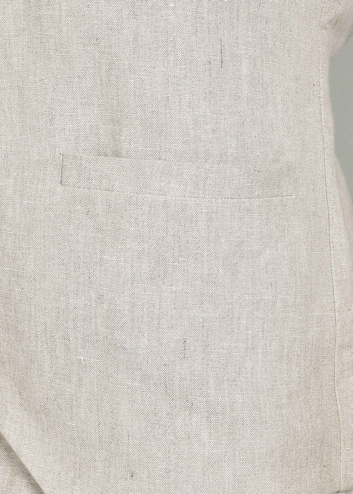Man wearing a 100% pure linen ecru waistcoat in 25 LEA over a white shirt against a gray background